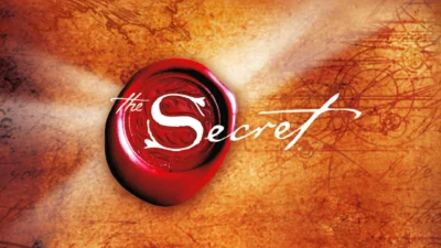 documentários para tratar a ansiedade: Imagem com textura de pergaminho antigo em tons de laranja e marrom, destacando um selo redondo de cera vermelha com a letra 'S' em relevo e a escrita em caligrafia branca 'the Secret'.